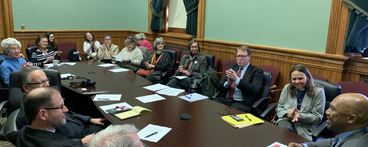 Iowa Episcopalians meet with lawmakers at the State House.