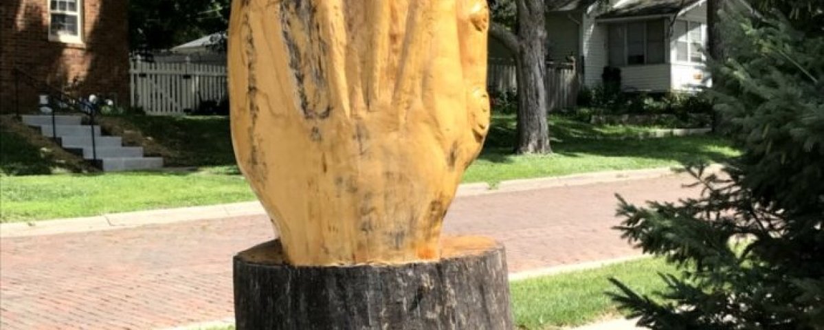 Praying hands sculpture created from storm damaged ash tree.