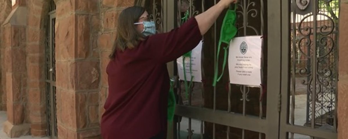 The Very Rev. Kristina Maulden hangs masks for the community