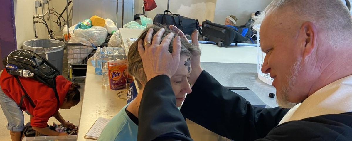 Ashes are placed on forehead of St. Peter's Outreach leader during Laundry Love