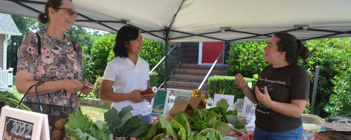 Beth Baier from North Merrick, and Amy Long, who teaches Brain and Body Yoga Classes at the church, chatted with Kristin Talbot about some of the produce. (Photo: TIM BAKER/HERALD)