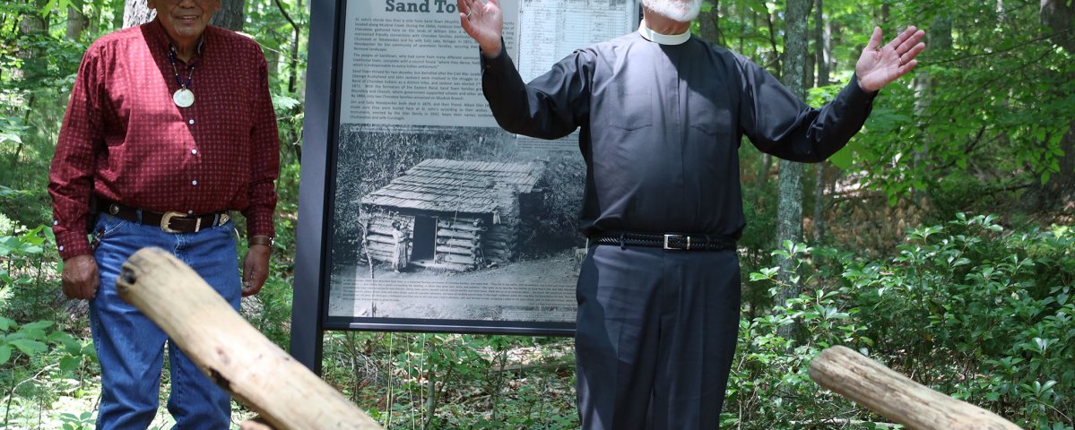 The Rev. Carl Southerland speaks after revealing the Sand Town sign. 
