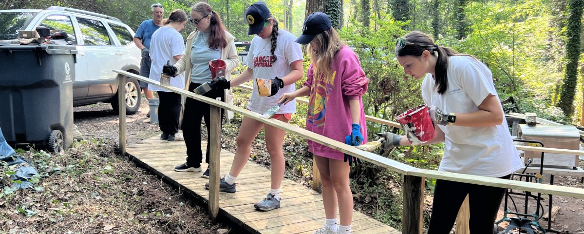 Towel Ministry campers paint a newly installed railing. 