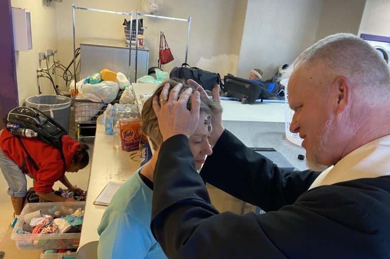 Ashes are placed on forehead of St. Peter's Outreach leader during Laundry Love