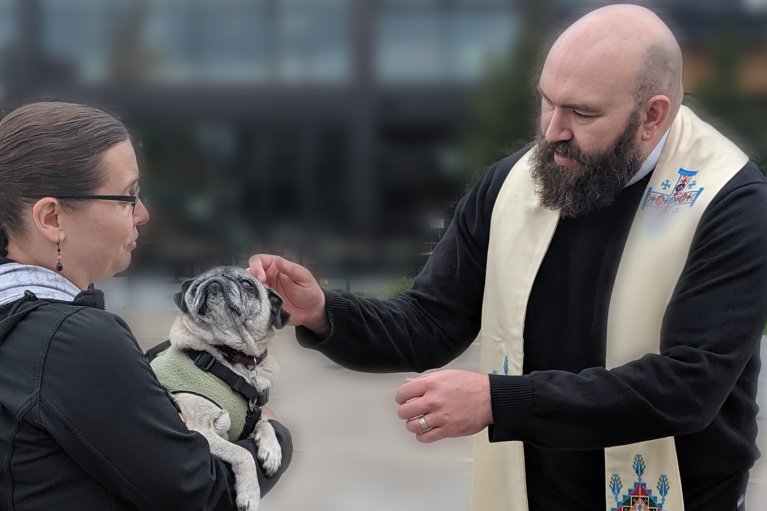 Father Jed Fox blessing a pet.