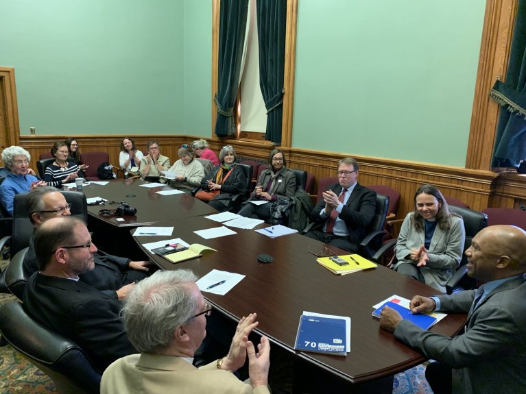 Iowa Episcopalians meet with lawmakers at the State House.