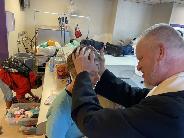 Ashes are placed on forehead of St. Peter's Outreach leader during Laundry Love