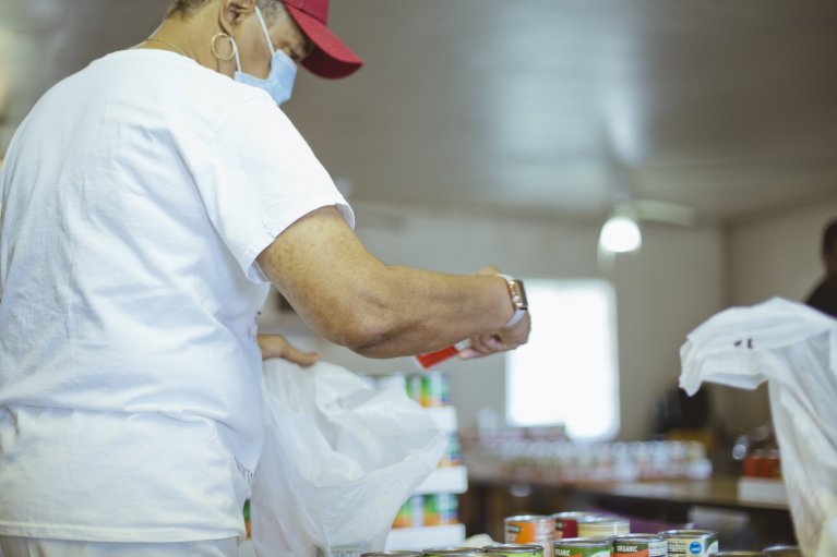 Volunteer sorting through food